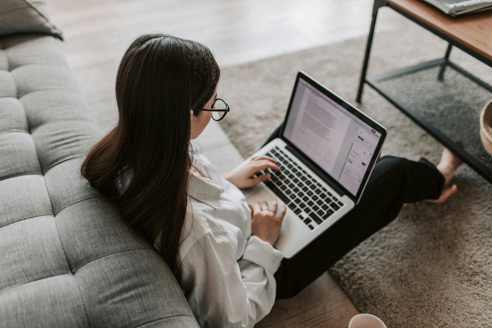 A person reviewing tax documents and using a tax preparation software on a computer